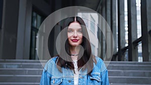 Portrait young caucasian attractive smile woman look at camera at urban city center feel happy fashion girl summer face