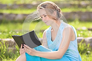 Portrait of Young Caucasian Blond Woman Reading Digital eBook O