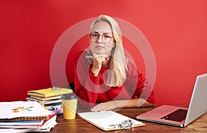 Portrait of young caucasian blonde female at work place