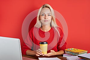 Portrait of young caucasian blonde female at work place