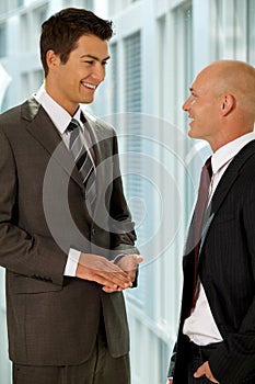 Portrait of young caucasian business people talking in office