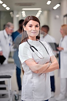 portrait of young caucasian confident doctor woman in white uniform posing at camera