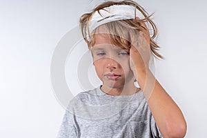 Portrait young caucasian cute boy blond hair with trauma injury and bandage head. Isolated on white background. Boy