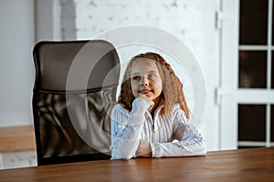 Portrait of young caucasian girl in casual clothes looks dreamful and happy