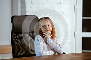 Portrait of young caucasian girl in casual clothes looks dreamful and happy