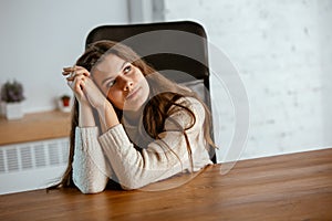 Portrait of young caucasian girl in casual clothes looks dreamful and happy