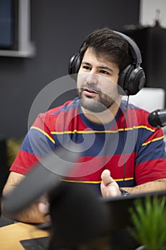 Portrait of young caucasian male with headphones in recording studio