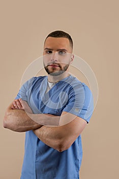 Portrait of young caucasian man doctor in blue uniform isolated, studio shoot