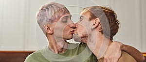 Portrait of young caucasian same sex male pair kissing