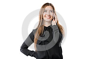 Portrait of a young caucasian woman in a black shirt and long flowing hair using hand-holding technology phone, taking a