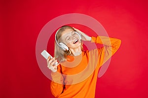 Portrait of young caucasian woman with bright emotions isolated on red studio background