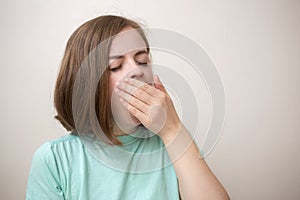 Portrait of young caucasian woman girl, yawning tired or sleepy