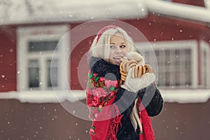 Portrait of a young caucasian woman in russian style on a strong frost in a winter snowy day. Russian model girl