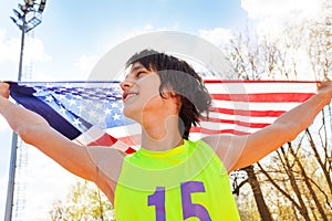 Portrait of young champion waving American flag