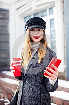 Portrait of young charming woman wearing fashionable glasses, business lady in elegant jacket , cute student in stylish cap . She