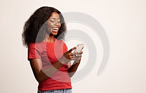 Portrait Of Young Cheerful Black Lady Using Smartphone For Messaging With Friends