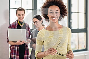 Portrait of young cheerful employee looking at camera in the off