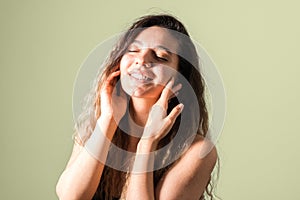 Portrait of a young cheerful woman with freckles skin green eyes and curly hairs in black t-shirt smiling. natural beauty and body