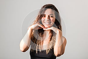 Portrait of a young cheerful woman with freckles skin green eyes and curly hairs in black t-shirt smiling. natural beauty and body