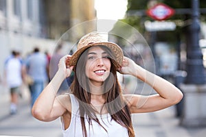 Portrait of a young cheerful woman in the street