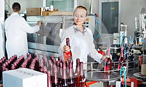 Woman working on wine production on manufactory photo