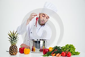 Portrait of a young chef cook preparing soup