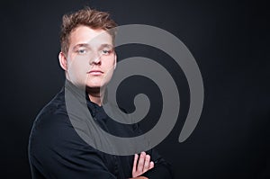 Portrait of young chef posing with folded arms