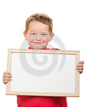 Portrait of young child boy holding blank sign with room for your copy