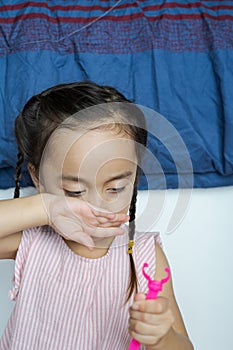 A portrait of young child with braided hair at home. Joy, fun, jovial and happy