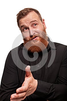 Portrait of a young, chubby, redheaded man in a black shirt making faces at the camera, isolated on a white background