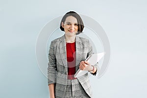 Portrait of young confident businesswoman in modern office. Woman-Owned Business,