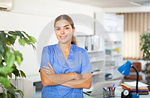 Portrait of a young female doctor standing in a resident's office