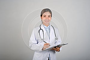 Portrait of young confident female doctor standing with white isolated background