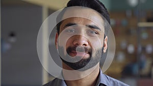 Portrait of young confident indian business man executive looking at camera.