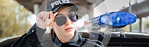 Portrait of young confident policewoman looking