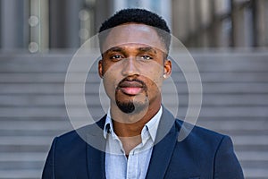 Portrait young confident successful African American businessman looking at camera close up face Serious black business man