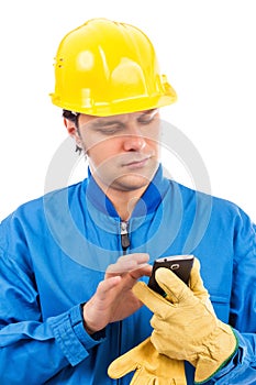 Portrait of a young construction worker using mobile phone