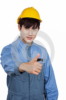 Portrait of young construction worker wearing yellow helmet in a Uniform mechanic