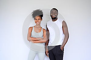 portrait of young couple of African Americans posing in fitness clothes over white background. Healthy and Fitness concept