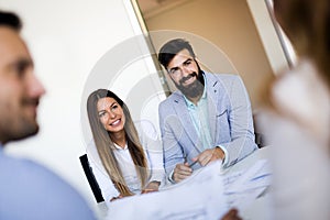 Portrait of young couple of architects on meeting