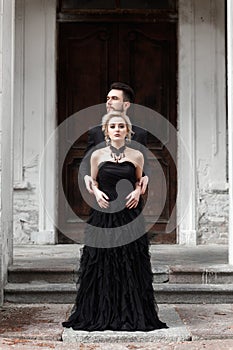 Portrait of a young couple in black suit and dress. Wedding