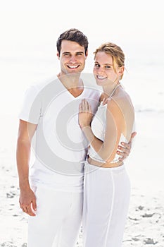 Portrait of young couple embracing each other on the beach