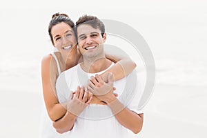 Portrait of young couple embracing each other on the beach