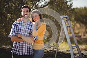 Portrait of young couple embracing at farm