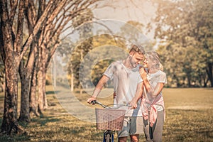 Portrait of Young couple enjoying in the park at sunset. Concept romantic and love. Warm tone