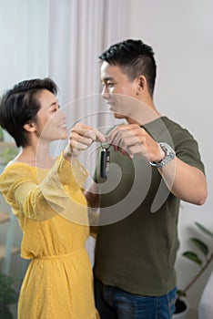 Portrait of young couple feeling happy about buying a new car