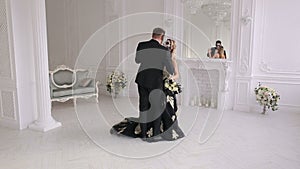 Portrait of a young couple in the Halloween mask in a beautiful interior.