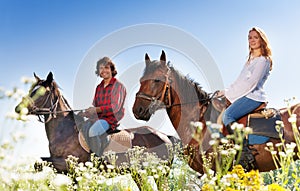 Portrait of young couple horseback riding