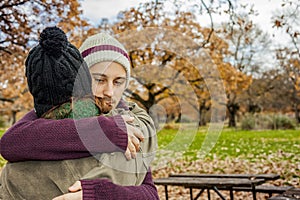 Portrait young couple hugging in an autumn background. Back view