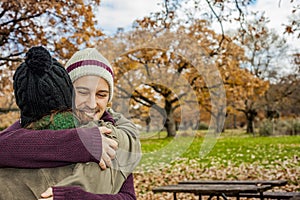 Portrait young couple hugging in an autumn background. Back view